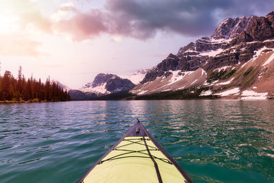 Scenic view of lake by mountains against sky