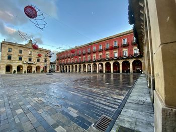 View of street and buildings against sky