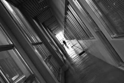 Tilt shot of man walking in corridor