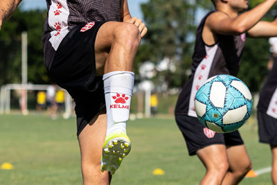 Midsection of man playing soccer ball