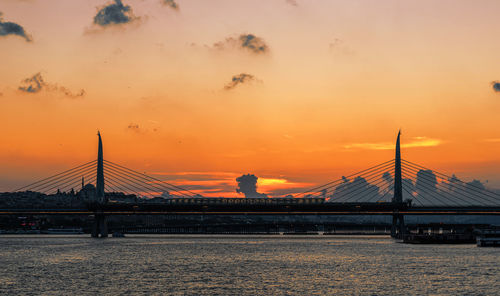 Silhouette bridge against sky during sunset