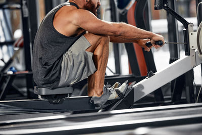 Low section of man exercising in gym