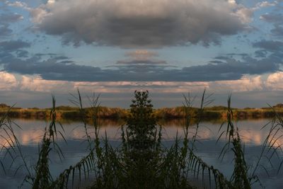 Scenic view of lake against sky at sunset