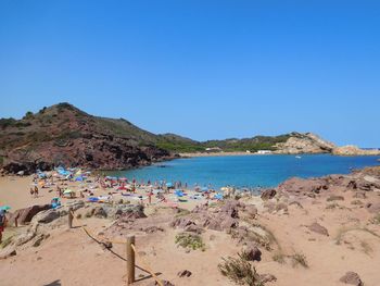 Scenic view of beach against clear blue sky