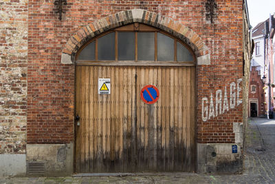 Road sign on wall of building