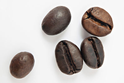 Close-up of coffee beans against white background