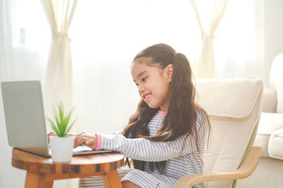 Woman sitting on table at home