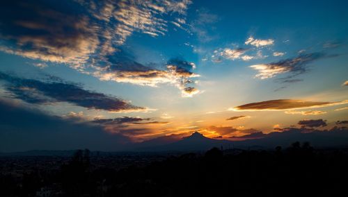 Scenic view of mountains against sky at sunset