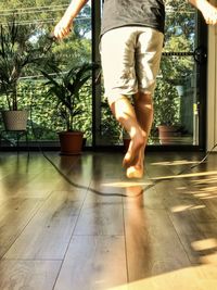 Low section of woman walking on tiled floor