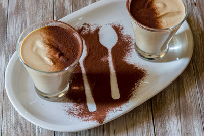 Coffee ricotta, spoon dessert in glass cup served in a white plate