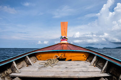 Boat moored on sea against sky