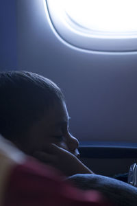 Close-up of person sleeping in airplane