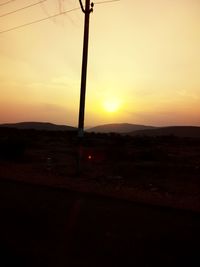 Scenic view of silhouette field against sky during sunset