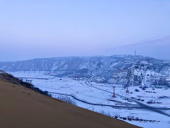 Scenic view of snow covered mountain against sky