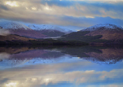 Scenic view of lake and mountains against sky