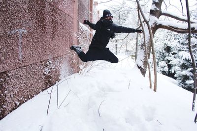 Full length of woman standing on snow