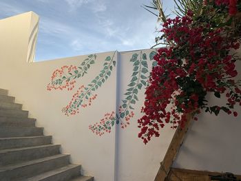 Low angle view of staircase by building against sky