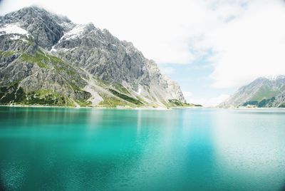 Scenic view of lake and mountains against sky