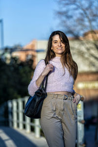 Portrait of woman standing in city