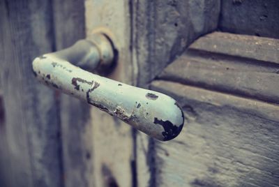 Close-up of rusty metal on wood