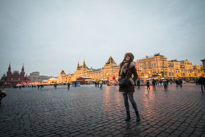 The girl enjoys exploring the city full of new year's magic