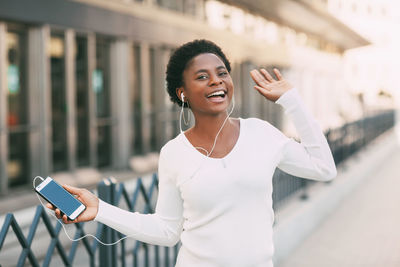 Portrait of smiling woman using mobile phone