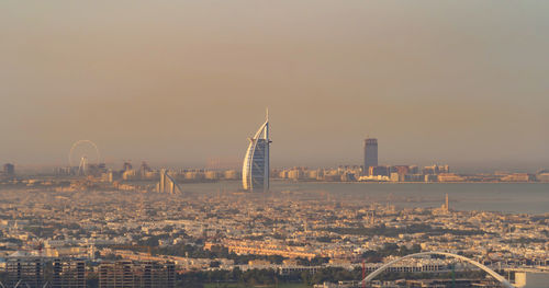 Aerial view of buildings in city during sunset