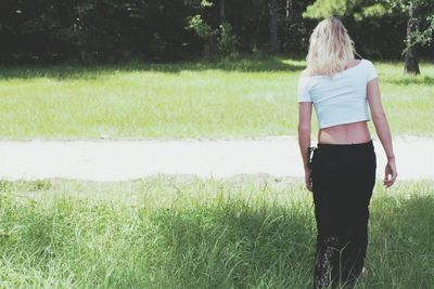 Rear view of woman standing on field