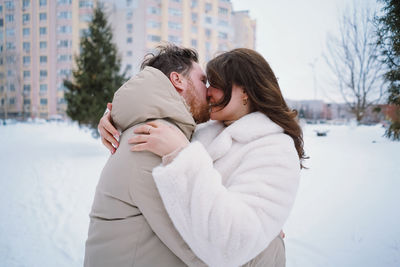 Rear view of woman holding snow