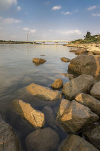 Rocks on beach against sky