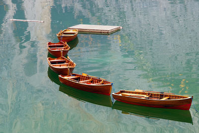 Rowboats moored in lake