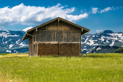 Barn on field against sky