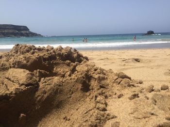 Scenic view of beach against clear sky