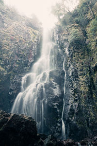 Scenic view of waterfall on mountain