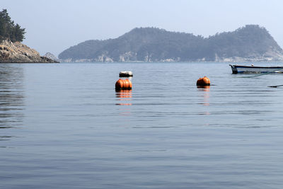 Boat floating on sea against sky