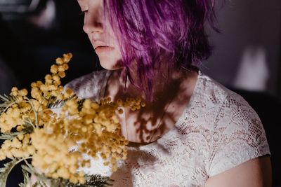 Woman with flowers looking away