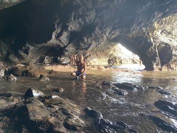 Rear view of people walking on rock