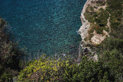 High angle view of rocks by sea