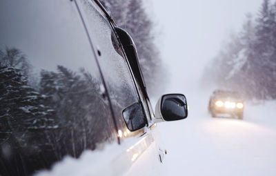 Close-up of car on snow covered road
