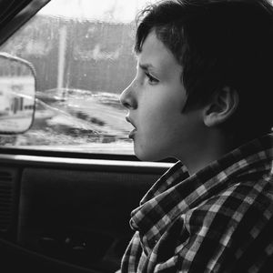 Close-up of thoughtful boy in car
