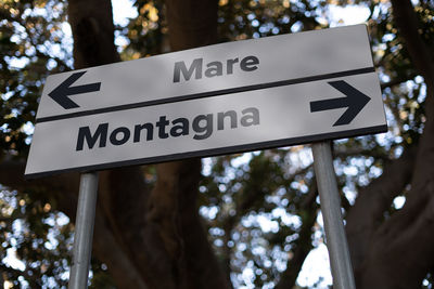 Low angle view of road sign against trees