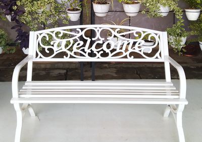 Empty chairs and table in yard