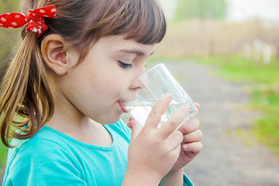 Close-up of young woman drinking juice