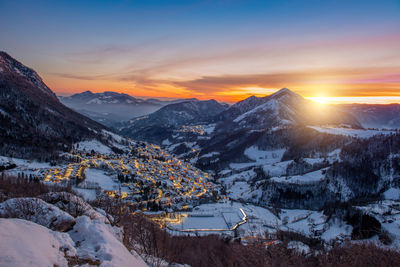 Scenic view of snowcapped mountains against sky during sunset