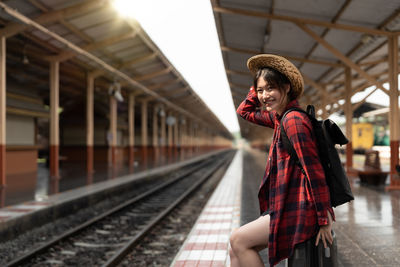 Rear view of woman standing in subway