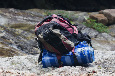 Midsection of man sitting on rock