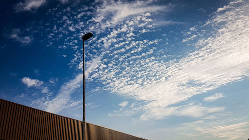 Low angle view of street light against building