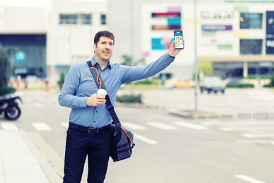 Full length of man standing on road in city