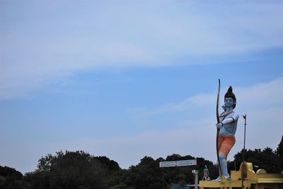 Low angle view of statue against blue sky