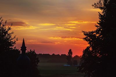 Silhouette trees against sky during sunset